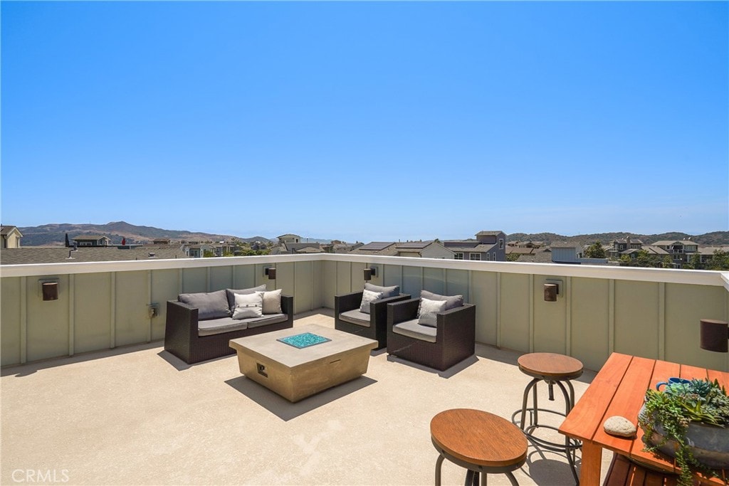 view of patio with an outdoor living space and a mountain view