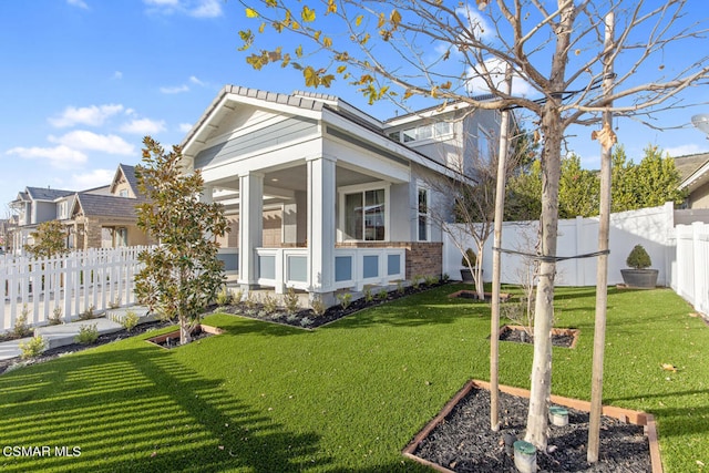 back of property featuring a sunroom and a yard