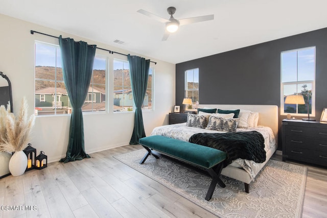 bedroom with ceiling fan and light wood-type flooring