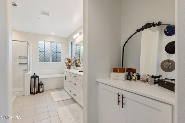 bathroom with tile patterned flooring, vanity, and shower with separate bathtub