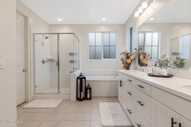 bathroom with tile patterned flooring, vanity, and independent shower and bath