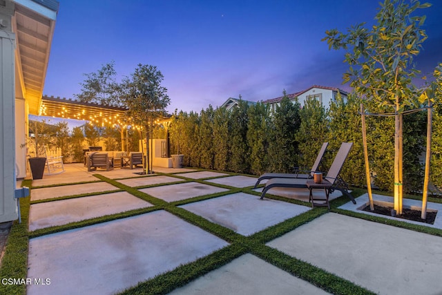 view of patio terrace at dusk