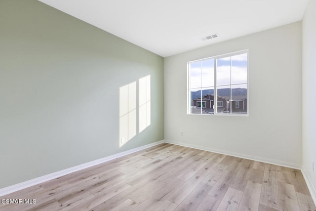 spare room featuring light hardwood / wood-style floors