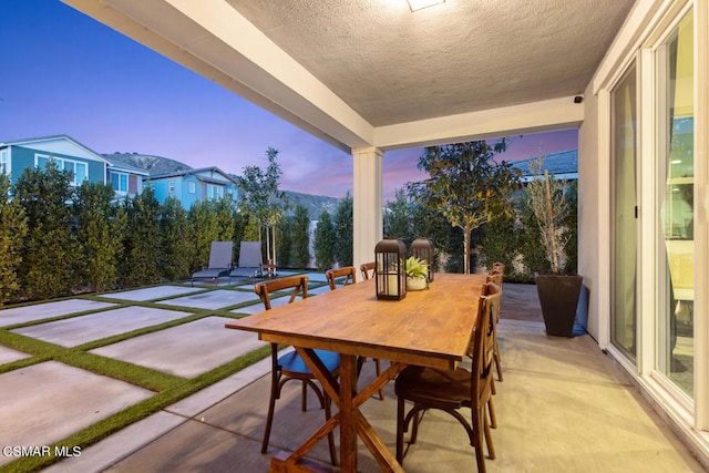 view of patio terrace at dusk