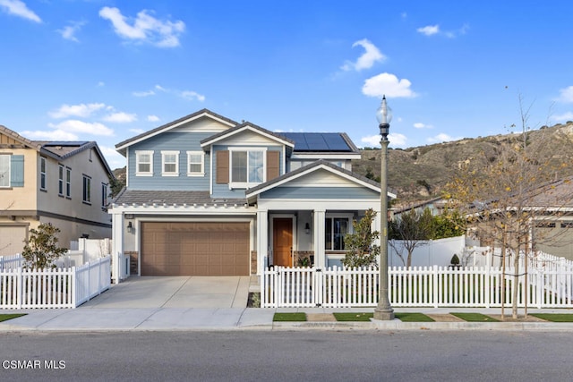 view of front facade featuring solar panels and a garage