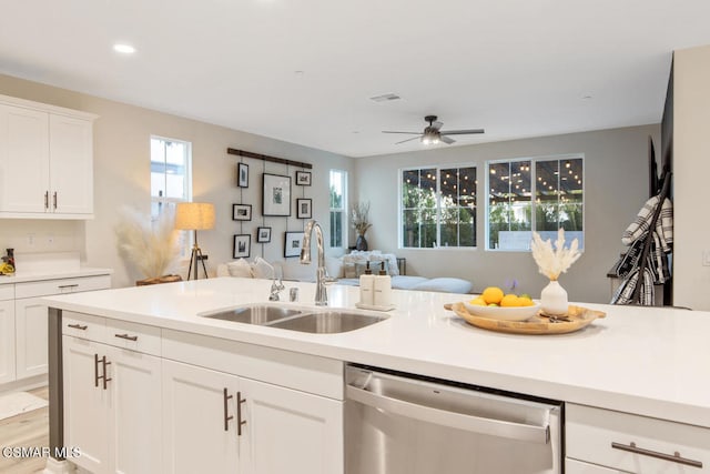 kitchen featuring dishwasher, sink, ceiling fan, and white cabinets