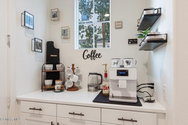 bar featuring white cabinets