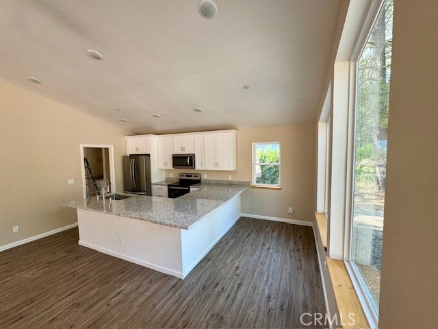 kitchen featuring white cabinets, kitchen peninsula, stainless steel appliances, dark hardwood / wood-style floors, and light stone countertops