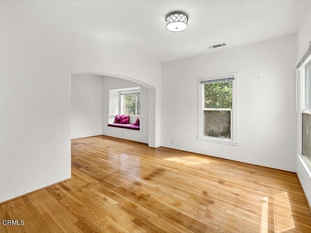 unfurnished room with wood-type flooring