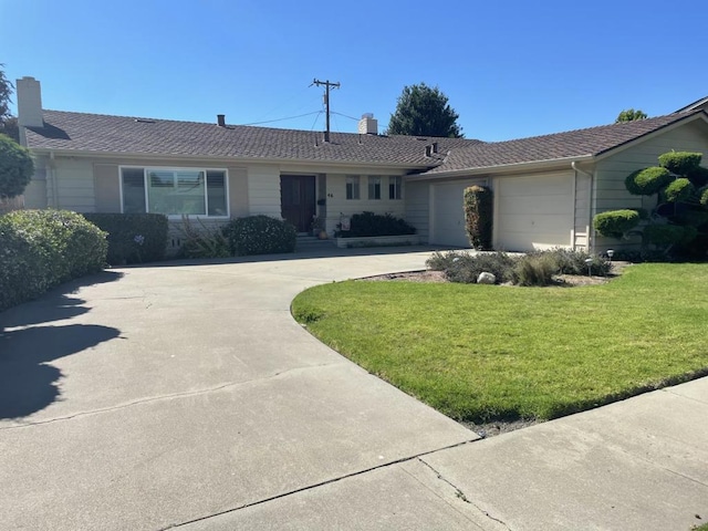 ranch-style house featuring a front yard and a garage