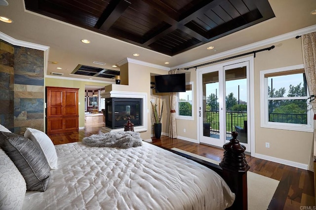 bedroom with dark hardwood / wood-style flooring, access to exterior, and multiple windows