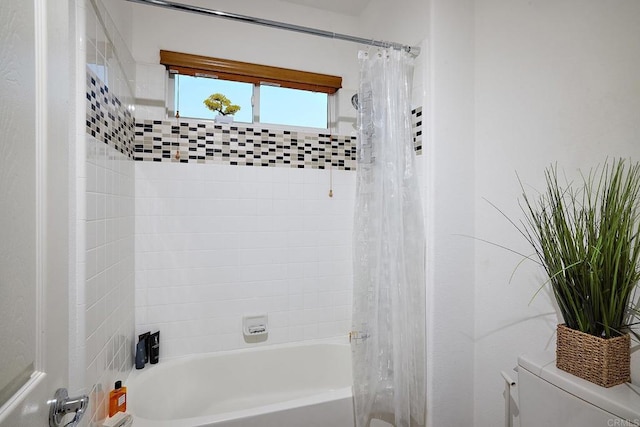 bathroom featuring toilet and shower / bath combo with shower curtain