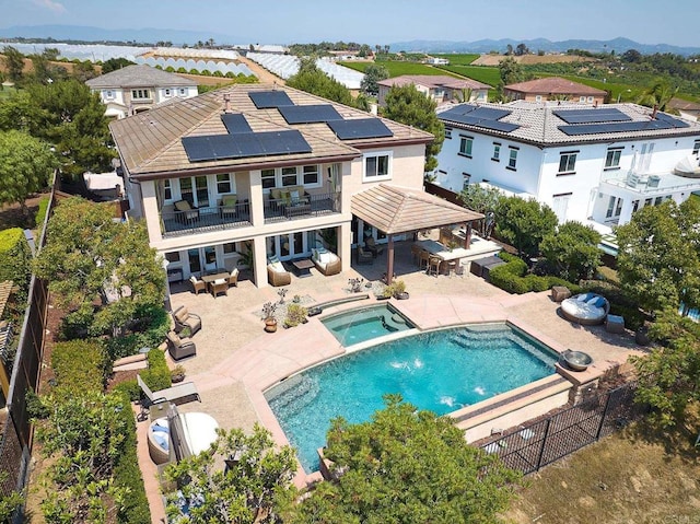 exterior space featuring a gazebo, an in ground hot tub, and a patio