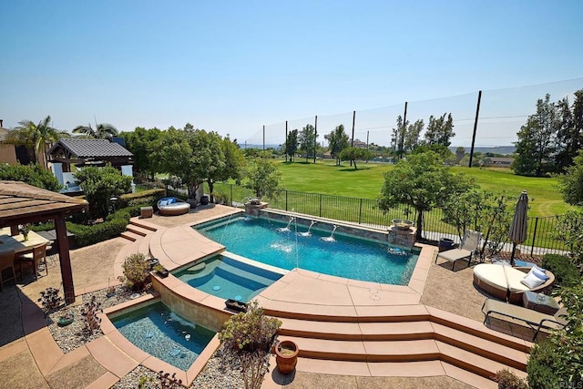 view of pool featuring a patio, a yard, an in ground hot tub, and pool water feature