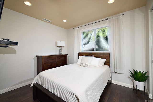 bedroom with dark wood-type flooring