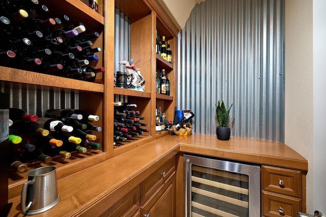 wine area featuring beverage cooler and indoor bar