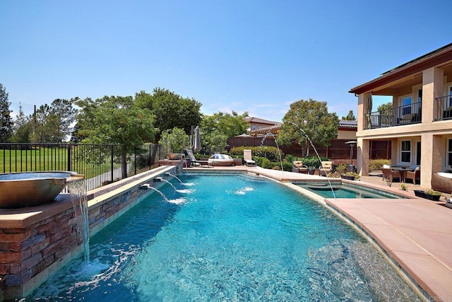 view of swimming pool featuring a patio area, an in ground hot tub, and pool water feature