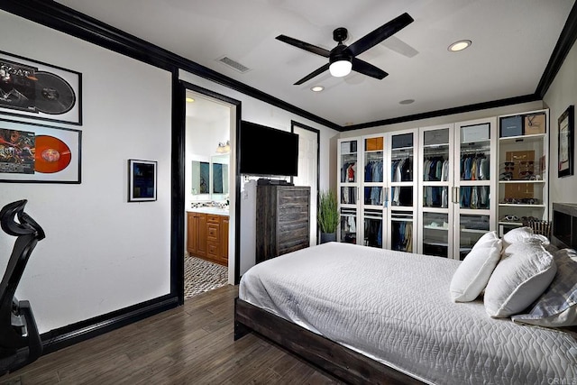 bedroom featuring ensuite bath, ceiling fan, dark hardwood / wood-style floors, and crown molding