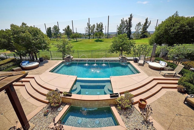 view of swimming pool with a lawn, an in ground hot tub, pool water feature, and a patio area