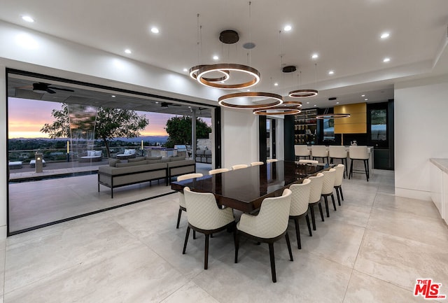 tiled dining space featuring ceiling fan