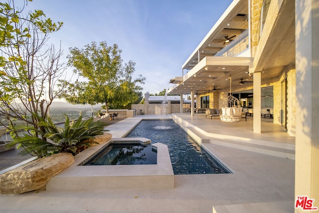 view of pool with a patio area, an in ground hot tub, and ceiling fan