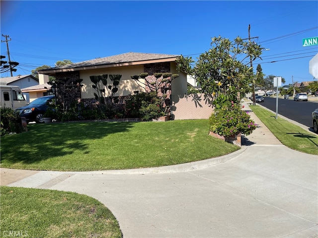 view of property exterior with a yard