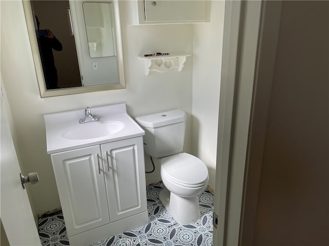 bathroom with vanity, toilet, and tile patterned flooring