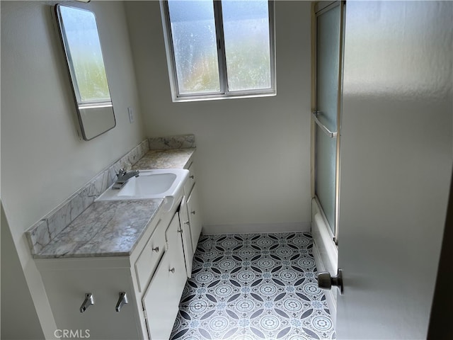 bathroom with vanity, plenty of natural light, and tile patterned flooring