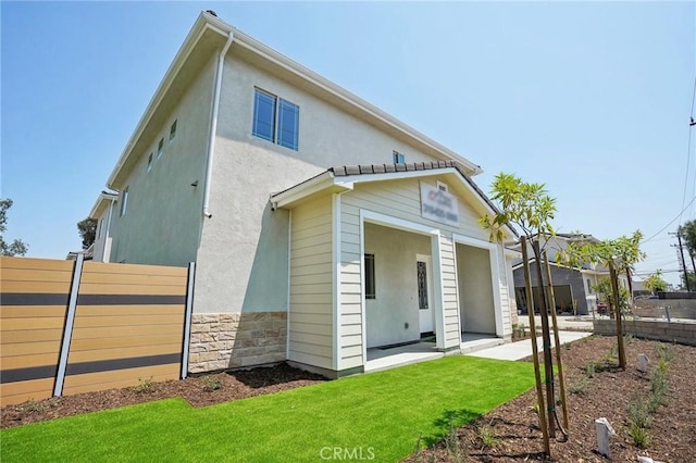 exterior space featuring a patio and a lawn