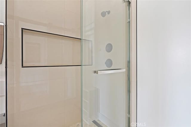 bathroom featuring a shower with door