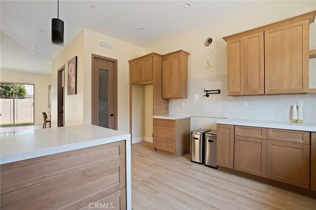 kitchen with hanging light fixtures and light hardwood / wood-style floors