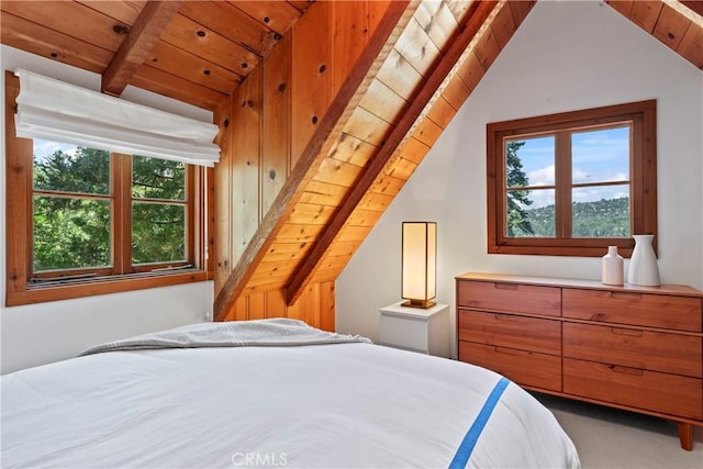 carpeted bedroom featuring lofted ceiling with beams and wood ceiling