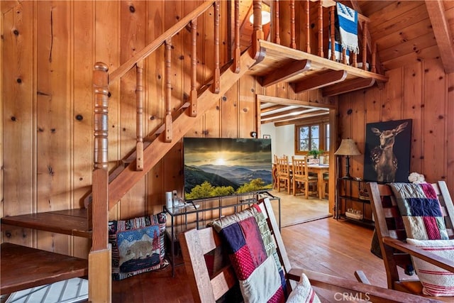 stairway featuring wood walls, wooden ceiling, vaulted ceiling, and hardwood / wood-style flooring