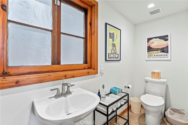 bathroom featuring sink, toilet, and tile patterned flooring