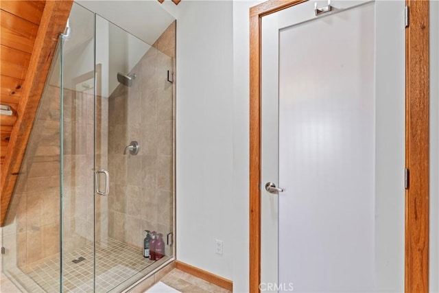 bathroom featuring a shower with door and tile patterned flooring