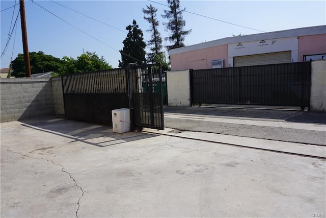 view of gate with a garage