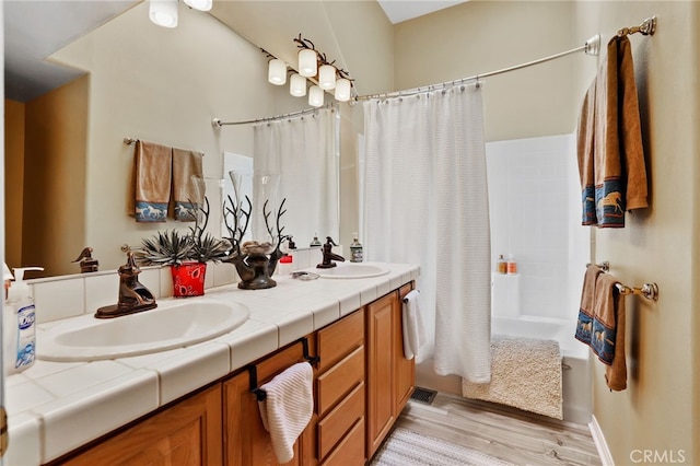 bathroom featuring vanity, shower / tub combo with curtain, and hardwood / wood-style flooring