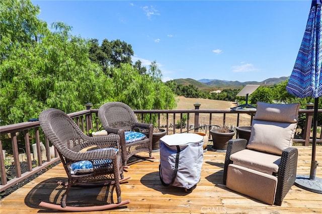 wooden deck with a mountain view