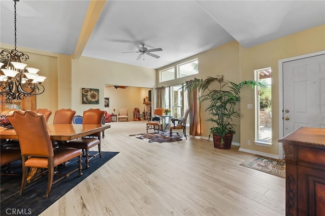 dining room featuring light hardwood / wood-style floors, beam ceiling, and ceiling fan with notable chandelier