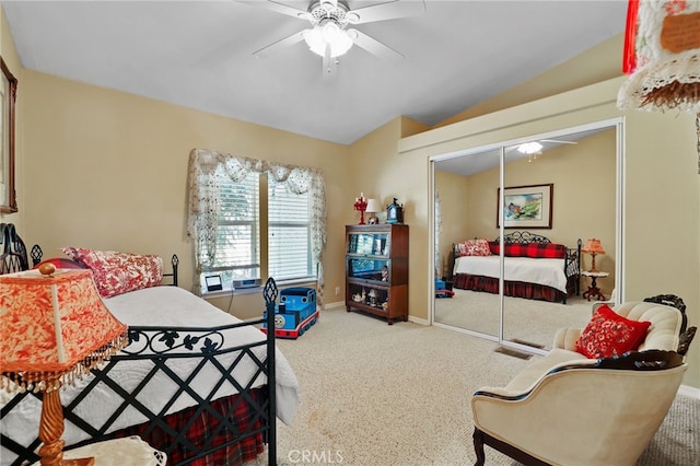 bedroom featuring carpet, a closet, vaulted ceiling, and ceiling fan