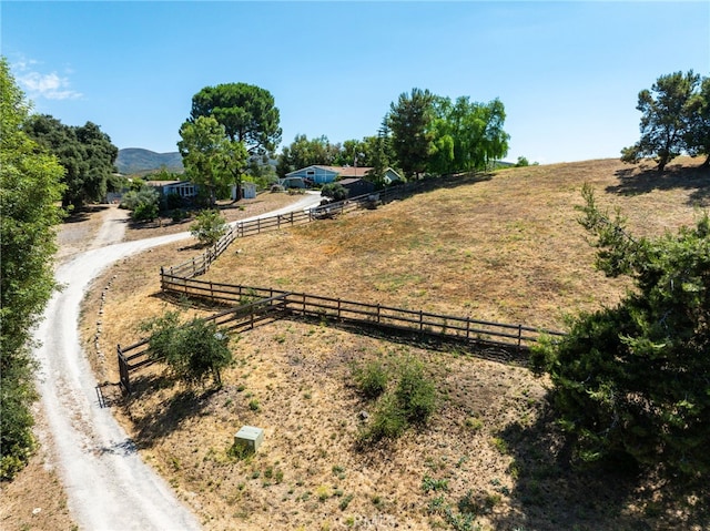 birds eye view of property featuring a mountain view and a rural view