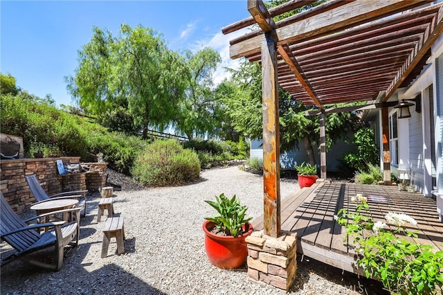 view of patio / terrace featuring a wooden deck and a pergola