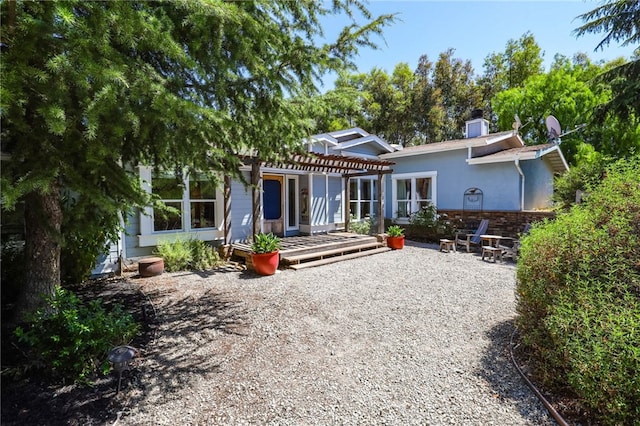 rear view of property featuring a patio area and a pergola