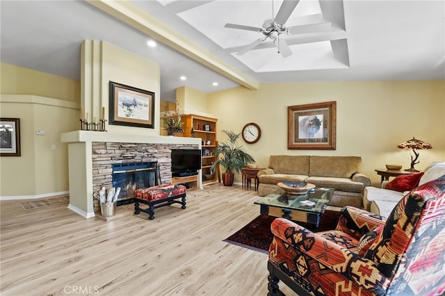 living room with vaulted ceiling with beams, a fireplace, light hardwood / wood-style floors, and ceiling fan