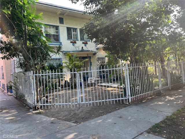 832 W 41st St, Los Angeles, CA 90037 - italianate house with a fenced front yard and stucco siding