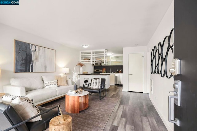 living room featuring dark hardwood / wood-style floors and sink