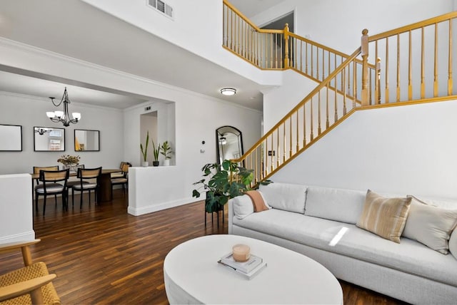 living room with crown molding, a notable chandelier, a high ceiling, and dark hardwood / wood-style flooring