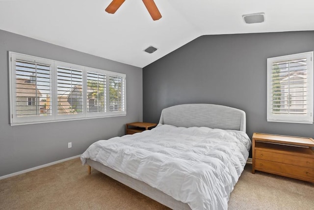 carpeted bedroom with ceiling fan, lofted ceiling, and multiple windows