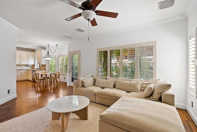 living room featuring ceiling fan, hardwood / wood-style flooring, and ornamental molding