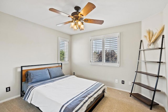 bedroom with light colored carpet and ceiling fan